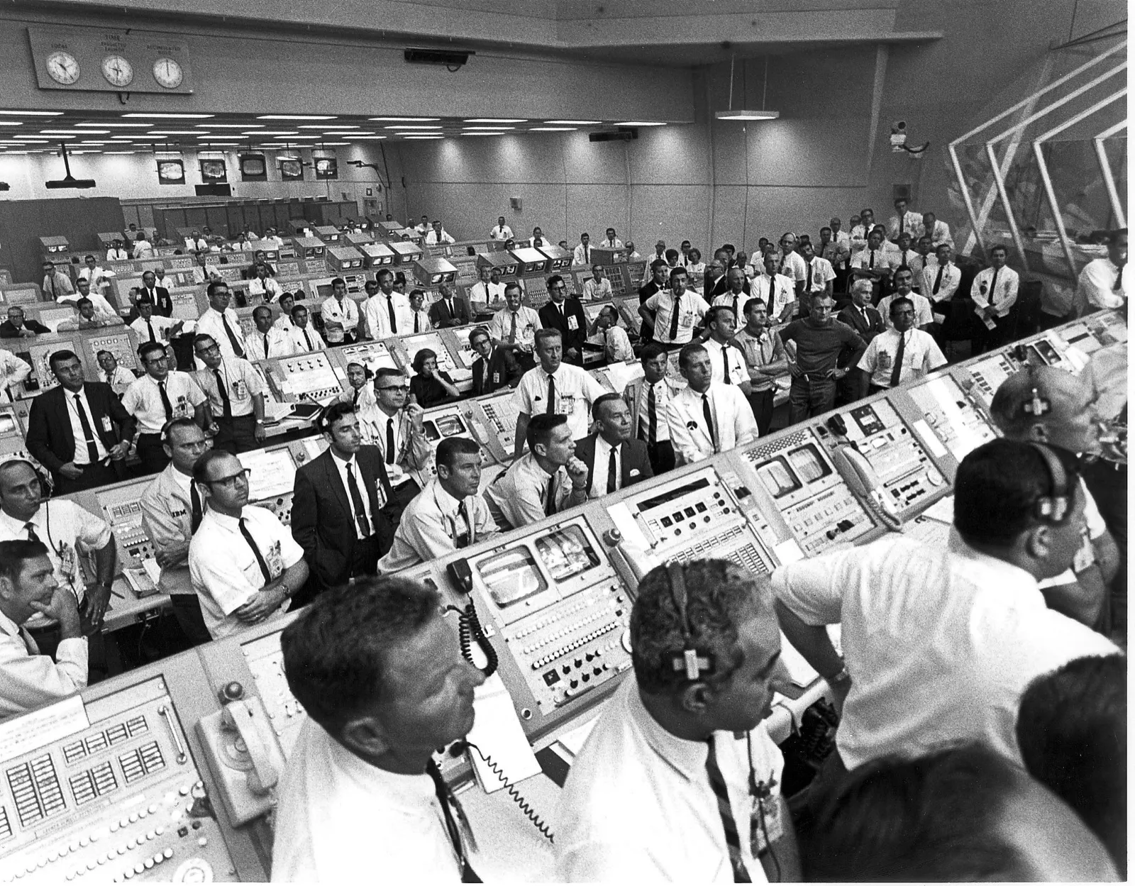 Firing Room 1, Kennedy Space Center, July 16, 1969 — flight controllers and engineers stand and sit at consoles watching the Apollo 11 launch.